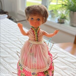 Vintage Doll Pin Cushion with Pink Floral Skirt and apron  1960s sewing needles